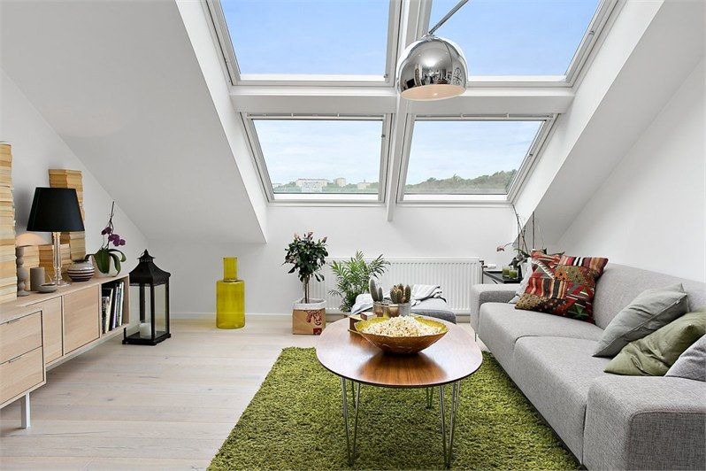 Bright attic living room with large skylight roof windows