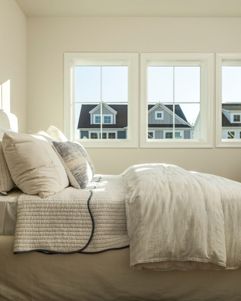 Bright bedroom interior with energy-efficient double-pane windows