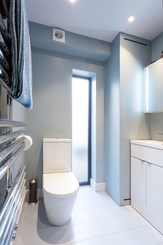 Modern bathroom with frosted window and energy-efficient ventilation fan