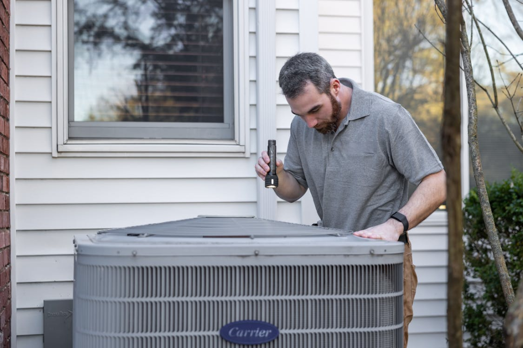 Technician Inspecting Outdoor HVAC Unit