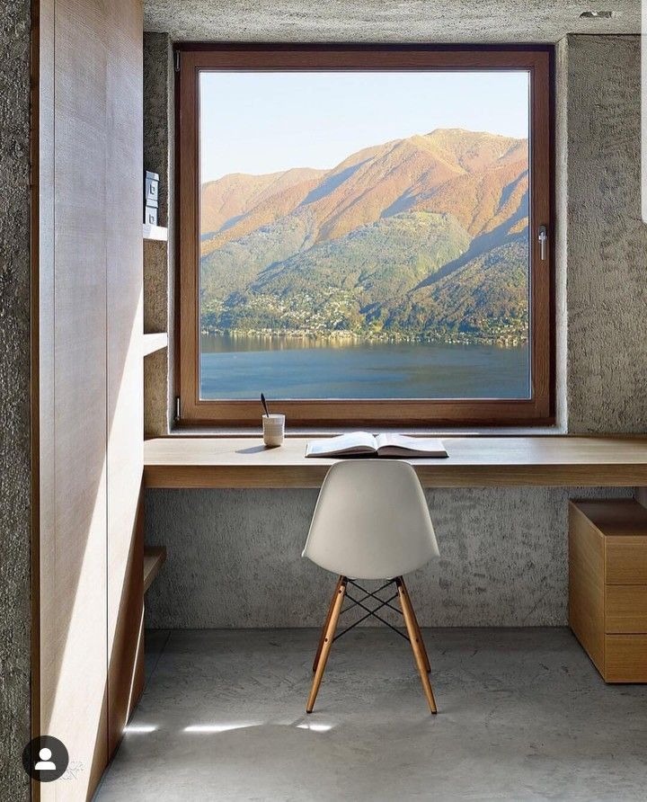 Large picture window with stunning mountain and lake view